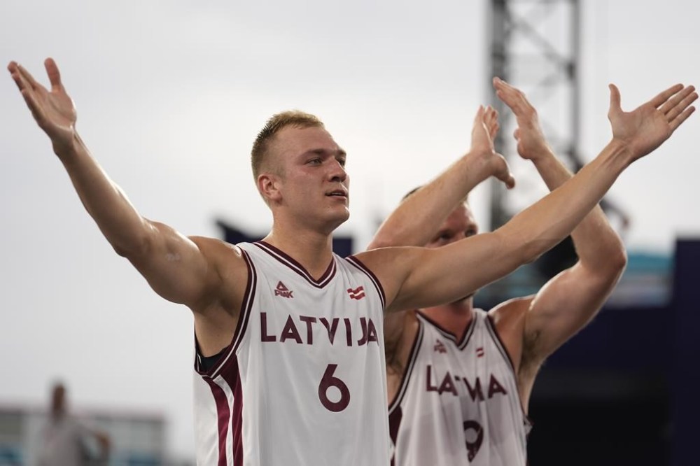 Latvia's Francis Lacis, left, and Latvia's Zigmars Raimo celebrate their win in the men's 3x3 basketball pool round match between Latvia and the Netherlands at the 2024 Summer Olympics, Wednesday, July 31, 2024, in Paris, France. (AP Photo/Rebecca Blackwell)