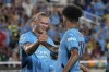 Manchester City midfielder Nico O'Reilly, right, celebrates his goal against Barcelona with teammate Erling Haaland during the first half of a Soccer Champions Tour match Tuesday, July 30, 2024, in Orlando, Fla. (AP Photo/John Raoux)