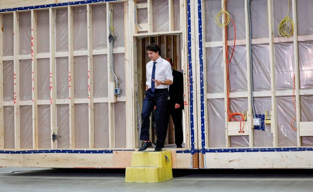 Prime Minister Justin Trudeau tours a modular home construction facility before making a housing announcement in Calgary on April 5. The federal government is aware that more productive methods are needed, and so is pushing to boost the more factory-style known as modular construction.THE CANADIAN PRESS/Jeff McIntosh
