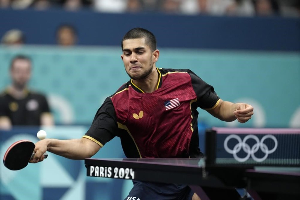 United States' Kanak Jha plays against Greece's Panagiotis Gionis during a men's singles round of 32 table tennis game at the 2024 Summer Olympics, Wednesday, July 31, 2024, in Paris, France. (AP Photo/Petros Giannakouris)