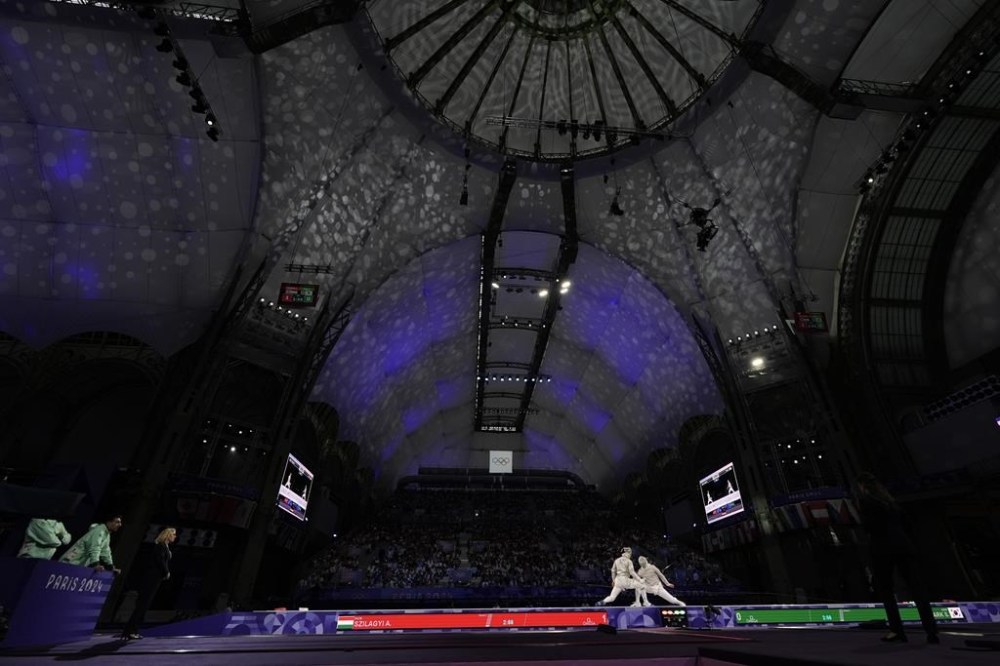 Hungary's Aron Szilagyi, left, competes with South Korea's Park Sangwon in the men's team sabre final match during the 2024 Summer Olympics at the Grand Palais, Wednesday, July 31, 2024, in Paris, France. (AP Photo/Andrew Medichini)