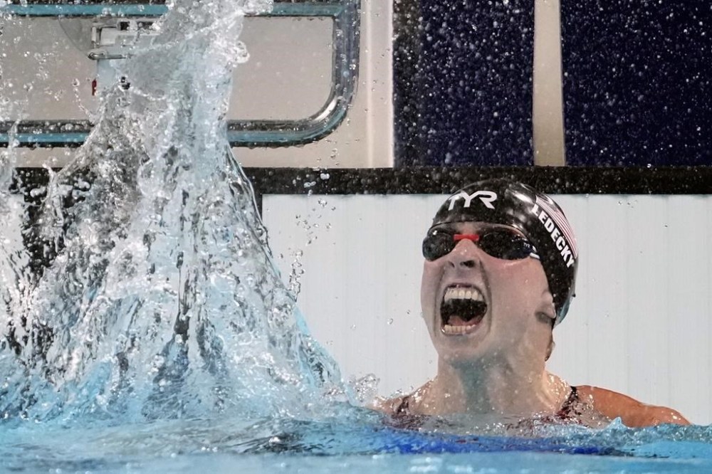 Katie Ledecky, of the United States, celebrates after winning the women's 1500-meter freestyle final at the 2024 Summer Olympics, Wednesday, July 31, 2024, in Nanterre, France. (AP Photo/Matthias Schrader)