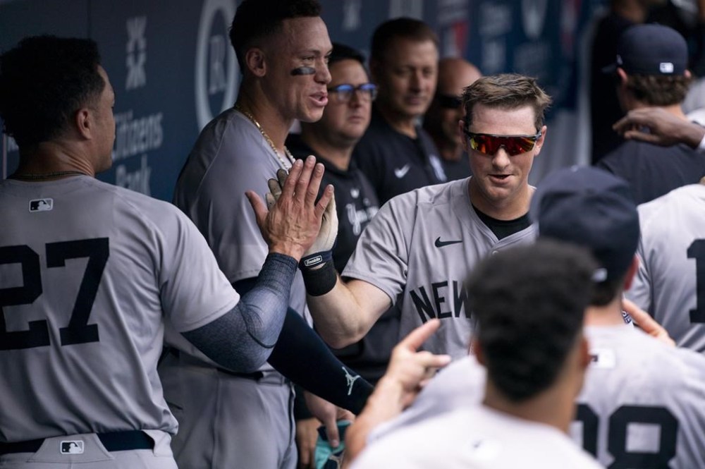 New York Yankees' DJ LeMahieu, center right, celebrates his grand slam with teammates during the second inning of a baseball game.against the Philadelphia Phillies, Wednesday, July 31, 2024, in Philadelphia. (AP Photo/Chris Szagola)