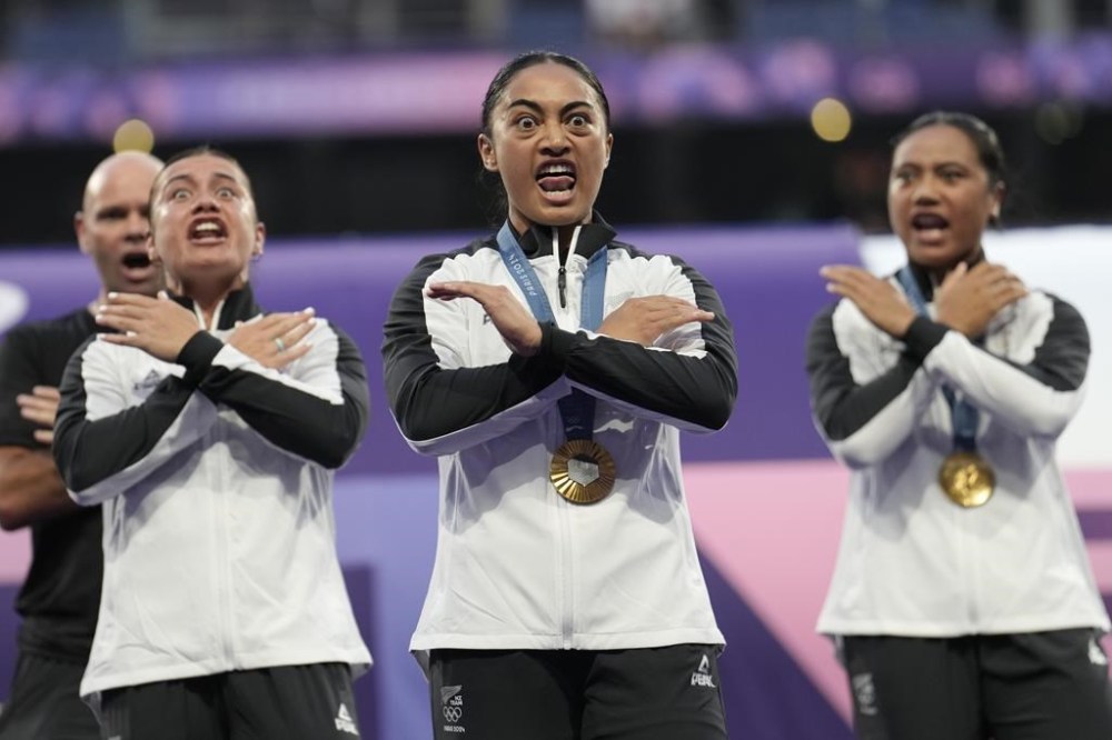 Members of the New Zealand Rugby Sevens team perform a Haka, after being presented with their gold medals at the 2024 Summer Olympics, in the Stade de France, in Saint-Denis, France, Tuesday, July 30, 2024. New Zealand defeated Canada in the gold medal match. (AP Photo/Vadim Ghirda)