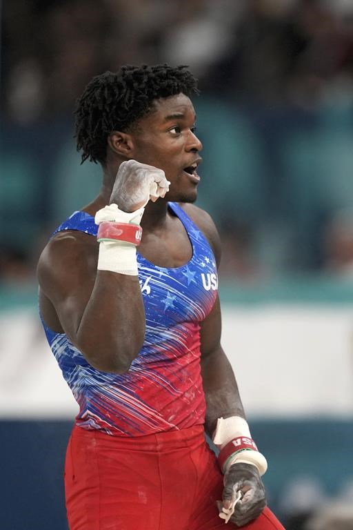Frederick Richard, of the United States, celebrates after performing on the horizontal bar during the men's artistic gymnastics all-around finals in Bercy Arena at the 2024 Summer Olympics, Wednesday, July 31, 2024, in Paris, France. (AP Photo/Charlie Riedel)