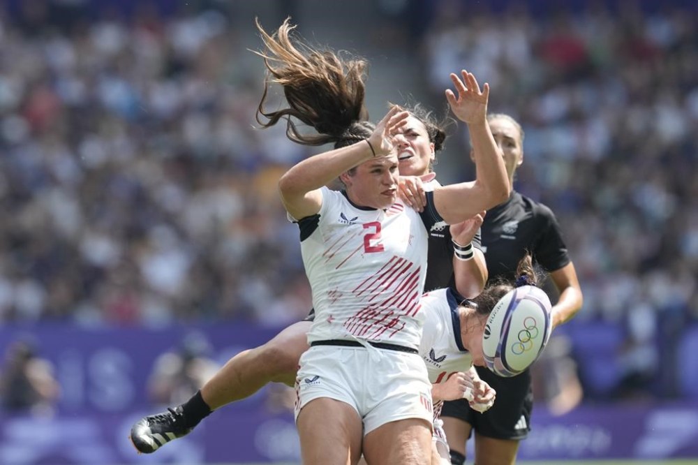 United States' Ilona Maher, front, leaps with New Zealand's Stacey Waaka for a high ball during the women's semifinal Rugby Sevens match between New Zealand and the United States at the 2024 Summer Olympics, in the Stade de France, in Saint-Denis, France, Tuesday, July 30, 2024. (AP Photo/Vadim Ghirda)
