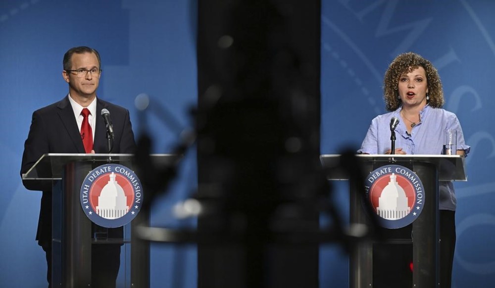 FILE - Rep. Celeste Maloy, R-Utah, speaks as Colby Jenkins looks on during Utah's 2nd Congressional district debate June 10, 2024, at the University of Utah, in Salt Lake City. Jenkins formally requested the recount in the election on Monday, July 29, but followed it up late Tuesday, July 30, with a lawsuit contesting the certification of results over 1,171 ballots that had been disqualified for late postmarking. (Scott G. Winterton/The Deseret News via AP, Pool, File)