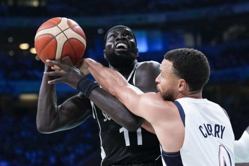Stephen Curry, of the United States, fools Marial Shayok, of South Sudan, in a men's basketball game at the 2024 Summer Olympics, Wednesday, July 31, 2024, in Villeneuve-d'Ascq, France. (AP Photo/Mark J. Terrill)