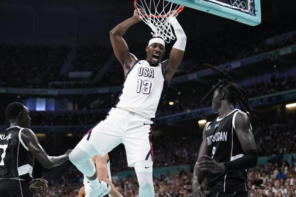 Bam Adebayo, of the United States, reacts after a dunk over Wenyen Gabriel, of South Sudan, in a men's basketball game at the 2024 Summer Olympics, Wednesday, July 31, 2024, in Villeneuve-d'Ascq, France. (AP Photo/Mark J. Terrill)