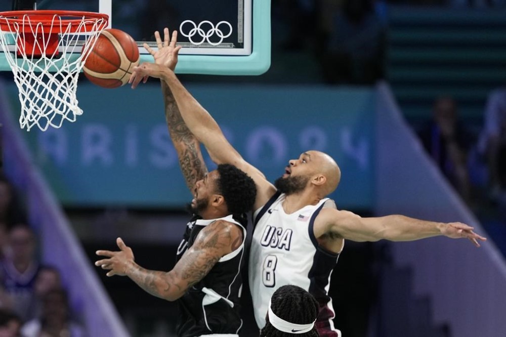 Derrick White, of the United States, blocks the shot of Carlik Jones, of South Sudan, in a men's basketball game at the 2024 Summer Olympics, Wednesday, July 31, 2024, in Villeneuve-d'Ascq, France. (AP Photo/Mark J. Terrill)