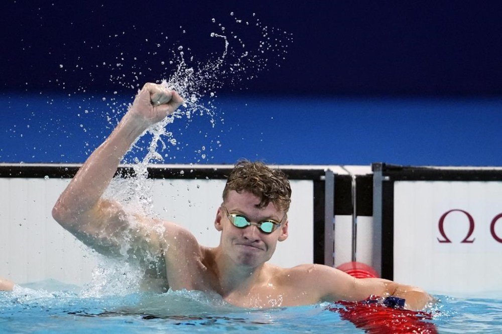 Leon Marchand, of France, celebrates after winning the men's 200-meter breaststroke final at the 2024 Summer Olympics, Wednesday, July 31, 2024, in Nanterre, France. (AP Photo/Matthias Schrader)