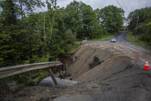 Cones guard a washed out roadway in the aftermath of flash floods in Lyndonville, Vermont, Wednesday, July 31, 2024. (AP Photo/Dmitry Belyakov)