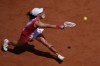 Iga Swiatek of Poland returns a shot to Zheng Qinwen of China during their women's semifinal tennis match at the 2024 Summer Olympics, Thursday, Aug.1, 2024, at the Roland Garros Stadium in Paris, France. (AP Photo/Andy Wong)