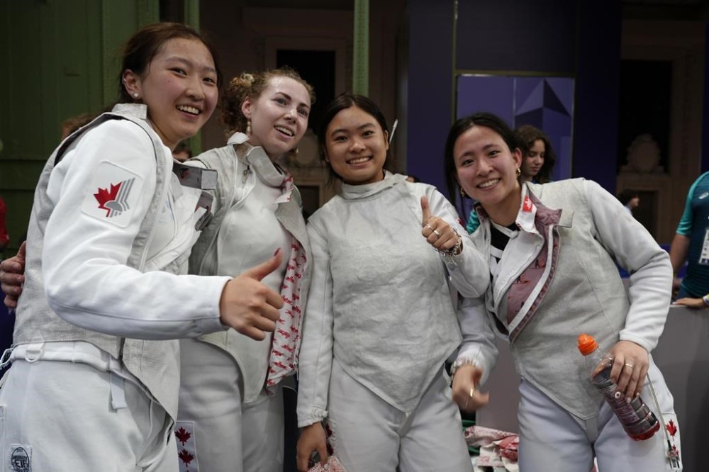 Canada's fencers celebrate after winning the women's team foil quarterfinal match against France during the 2024 Summer Olympics at the Grand Palais, Thursday, Aug. 1, 2024, in Paris, France. THE CANADIAN PRESS/AP/Andrew Medichini