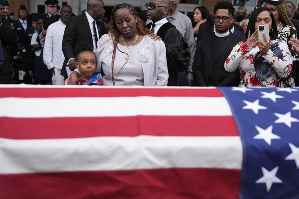 FILE - Chantemekki Fortson the mother of slain airman Roger Fortson, right, along with family watch Fortson's casket as they leave for a cemetery during his funeral at New Birth Missionary Baptist Church, on May 17, 2024, in Stonecrest, Ga. (AP Photo/Brynn Anderson, File)