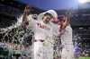 Philadelphia Phillies' Tyler Phillips, left, is doused by Brandon Marsh and Bryson Stott, right, after their victory over the Cleveland Guardians, Saturday, July 27, 2024, in Philadelphia. (AP Photo/Derik Hamilton)