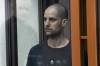 FILE - Wall Street Journal reporter Evan Gershkovich stands listening to the verdict in a glass cage of a courtroom inside the building of 
