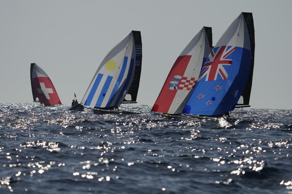 Boats sail before the men's skiff race was canceled due to the wind, during the 2024 Summer Olympics, Thursday, Aug. 1, 2024, in Marseille, France. (AP Photo/Carolyn Kaster)