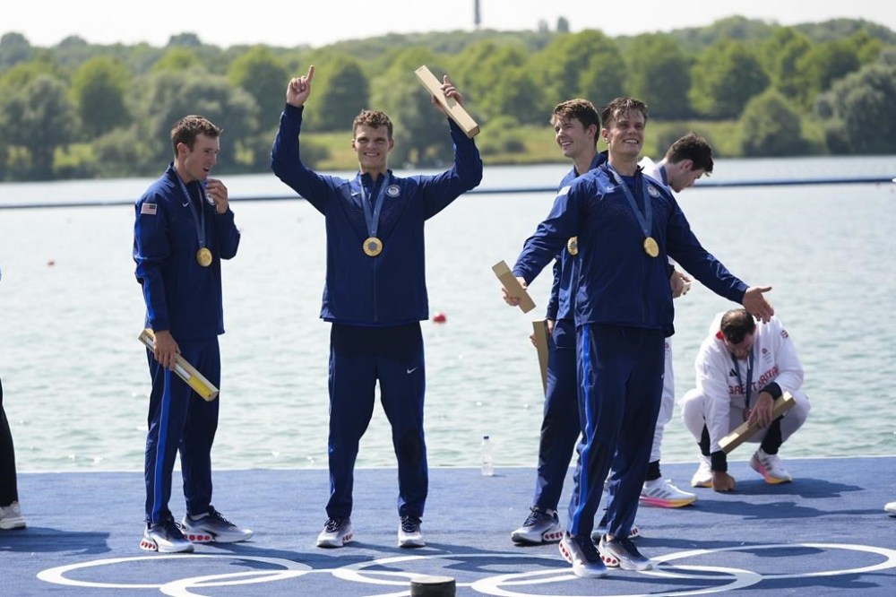 United States' Liam Corrigan, Michael Grady, Justin Best and Nick Mead celebrate gold during a medals ceremony for the men's four final at the 2024 Summer Olympics, Thursday, Aug. 1, 2024, in Vaires-sur-Marne, France. (AP Photo/Lindsey Wasson)
