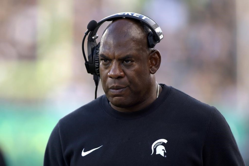 FILE - Michigan State coach Mel Tucker walks the sideline during the second half of an NCAA college football game against Richmond, on Sept. 9, 2023, in East Lansing, Mich. Former Michigan State University head football coach Mel Tucker is suing the university and school leaders, alleging that they wrongfully fired him last year and violated his constitutional rights amid a sexual harassment case. The federal lawsuit filed Wednesday, July 31, 2024, in Michigan accuses school officials of undertaking an “improper, sham investigation” of allegations that Tucker sexually harassed and exploited rape survivor and activist Brenda Tracy. (AP Photo/Al Goldis, File)