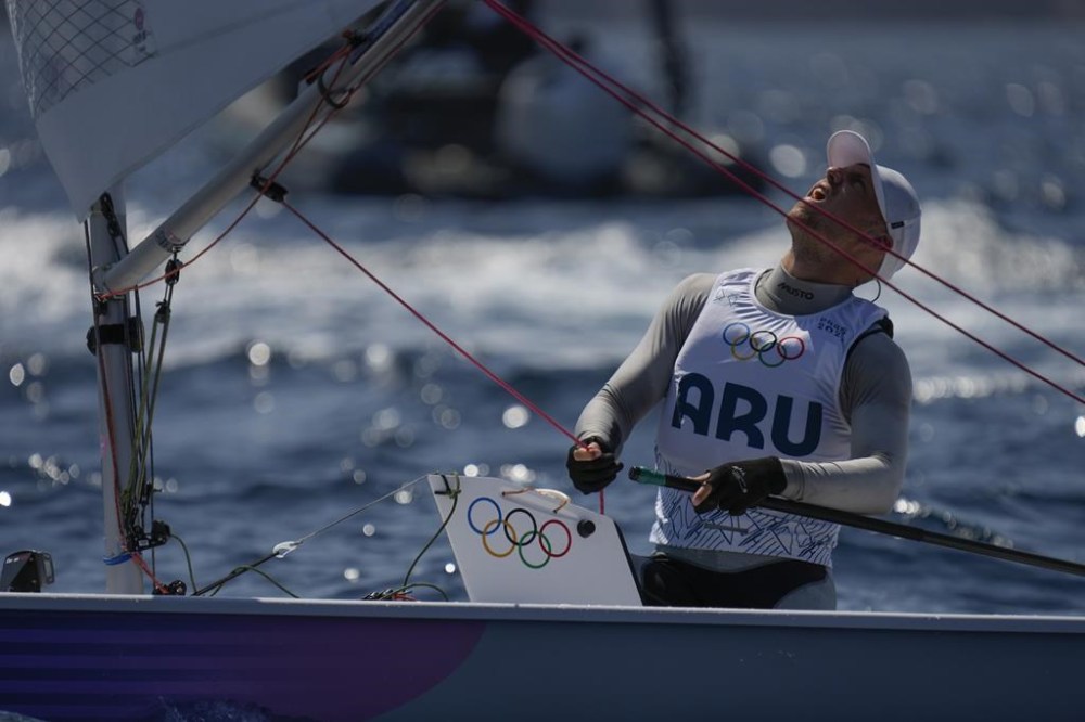 Just van Aanholt of Aruba checks the sail before the start of a men's dinghy race, during the 2024 Summer Olympics, Thursday, Aug. 1, 2024, in Marseille, France. (AP Photo/Carolyn Kaster)