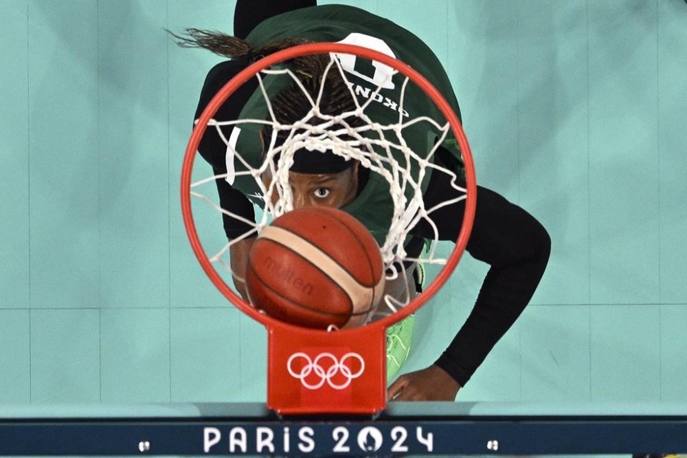 Nigeria's Amy Okonkwo watches the ball go in during a women's basketball game against France at the 2024 Summer Olympics, Thursday, Aug. 1, 2024, in Villeneuve-d'Ascq, France. (Sameer Al-Doumy/Pool Photo via AP)