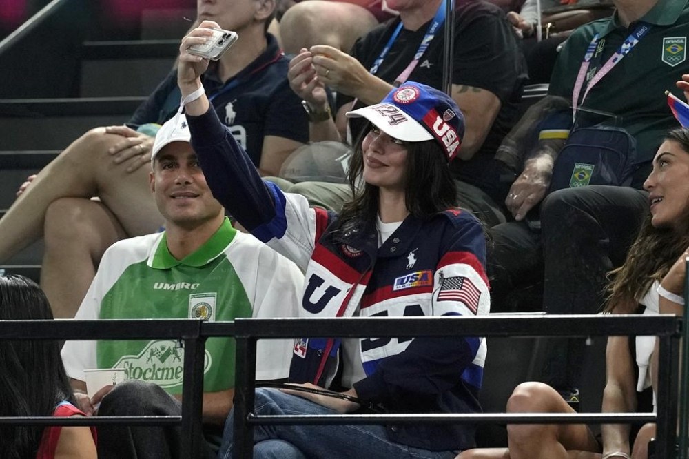 Kendall Jenner takes a selfie during the women's artistic gymnastics all-around finals in Bercy Arena at the 2024 Summer Olympics, Thursday, Aug. 1, 2024, in Paris, France. (AP Photo/Abbie Parr)