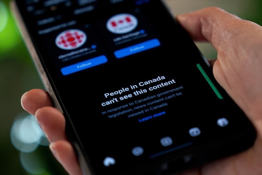 A new report is painting a grim portrait of how local Canadian news outlets are faring one year after Meta began blocking Canadian news content on its Facebook and Instagram platforms. A smartphone showing Meta's blocking of Canadian news content on their Instagram social media app is shown in a photo illustration, in Toronto, Aug. 1, 2024. THE CANADIAN PRESS/Giordano Ciampini