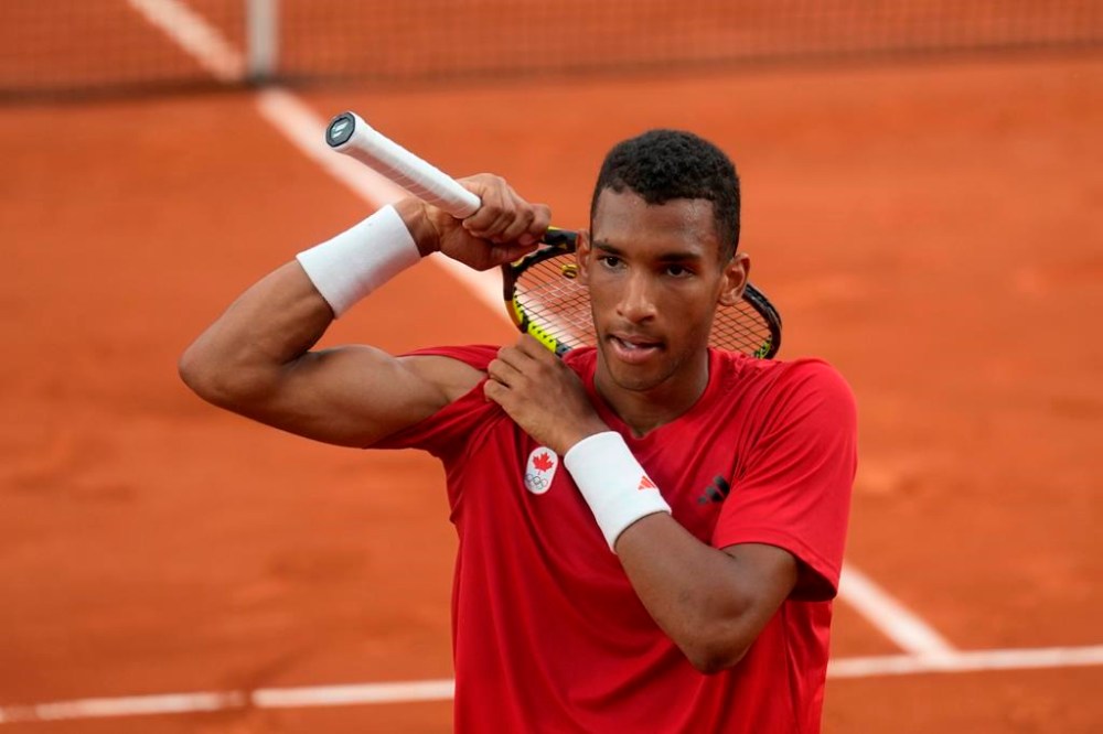 Canada's Felix Auger-Aliassime flexes after beating Norway's Casper Ruud during men's singles quarter-final tennis action at the Summer Olympics in Paris on Thursday, Aug.1, 2024. THE CANADIAN PRESS/Adrian Wyld