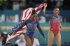 Simone Biles, left, celebrates with teammate Suni Lee, of the United States, after winning the gold and bronze medals respectively in the women's artistic gymnastics all-around finals in Bercy Arena at the 2024 Summer Olympics, Thursday, Aug. 1, 2024, in Paris, France. (AP Photo/Abbie Parr)