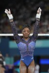 Simone Biles, of the United States, performs on the uneven bars during the women's artistic gymnastics all-around finals in Bercy Arena at the 2024 Summer Olympics, Thursday, Aug. 1, 2024, in Paris, France. (AP Photo/Natacha Pisarenko)