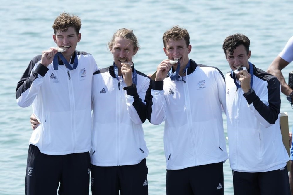 New Zealand's Tom Murray, Logan Ullrich, Matt MacDonald and Ollie MacLean pose with the silver medal in the men's four final at the 2024 Summer Olympics, Thursday, Aug. 1, 2024, in Vaires-sur-Marne, France. (AP Photo/Ebrahim Noroozi)