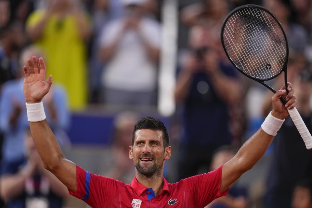 Serbia's Novak Djokovic celebrates his victory over Stefanos Tsitsipas of Greece during their men's quarter-final match at the Roland Garros stadium, at the 2024 Summer Olympics, Thursday, Aug. 1, 2024, in Paris, France. (AP Photo/Manu Fernandez)