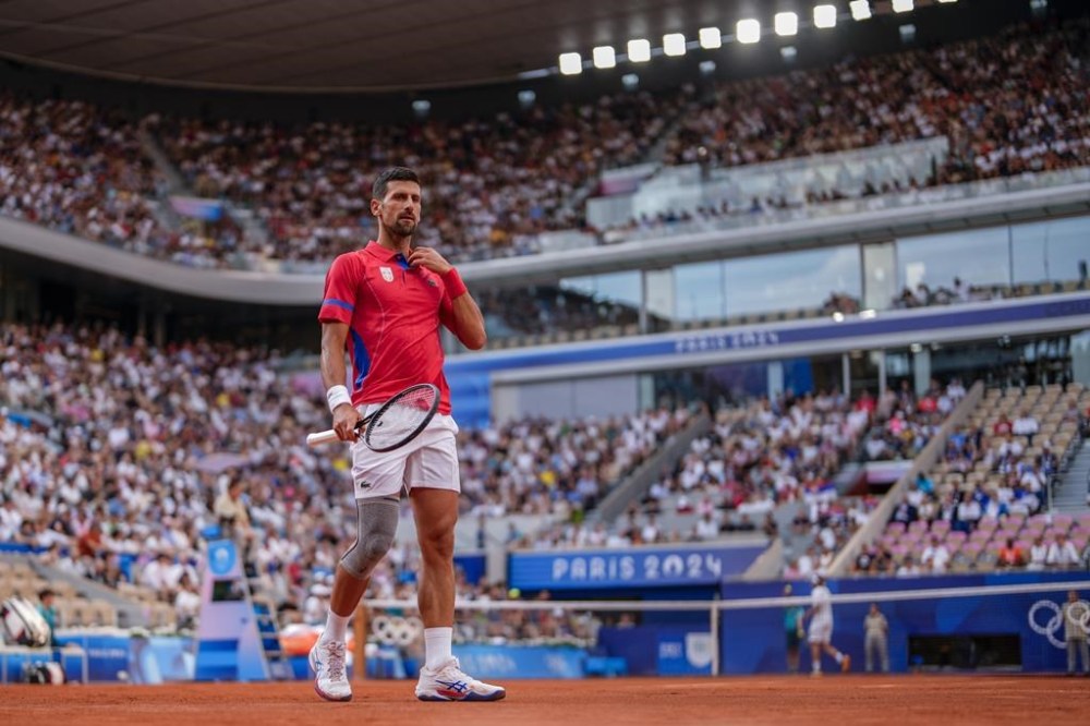 Serbia's Novak Djokovic competes against Stefanos Tsitsipas of Greece during their men's quarter-final match at the Roland Garros stadium, at the 2024 Summer Olympics, Thursday, Aug. 1, 2024, in Paris, France. (AP Photo/Manu Fernandez)