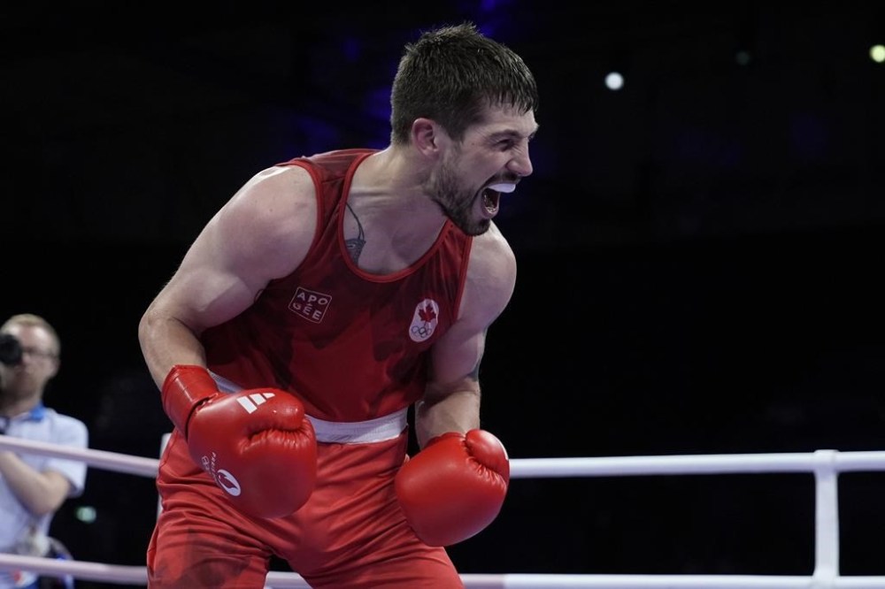 Canada's Wyatt Sanford celebrates after defeating Uzbekistan's Ruslan Abdullaev in their men's 63.5-kg quarterfinal boxing match at the 2024 Summer Olympics, Aug. 1, in Paris, France. THE CANADIAN PRESS/AP, John Locher
