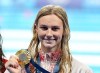 Canada's Summer McIntosh, of Toronto, celebrates with her gold medal after setting a new Olympic record in the 200m women's butterfly final during the 2024 Summer Olympic Games, in Paris, Thursday, Aug. 1, 2024. THE CANADIAN PRESS/Christinne Muschi
