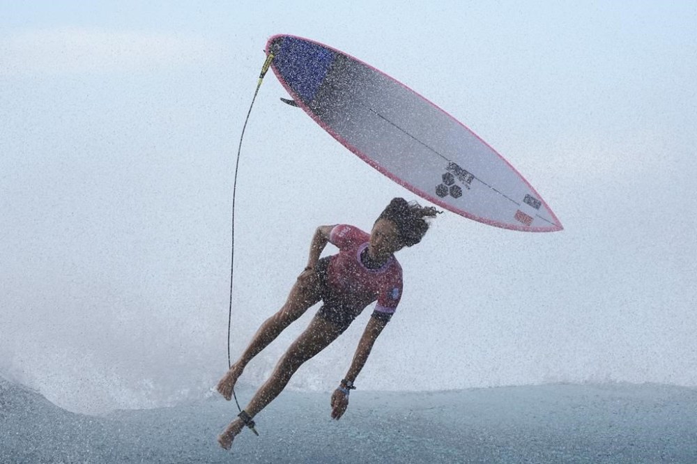 Vahine Fierro, of France, kicks off of a wave during the third round of the 2024 Summer Olympics surfing competition, Thursday, Aug. 1, 2024, in Teahupo'o, Tahiti. (AP Photo/Gregory Bull)