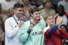 Apostolos Christou, of Greece, from left, Hubert Kos, of Hungary, and Roman Mityukov, of Switzerland, celebrate during the awards ceremony for the men's 200-meter backstroke at the 2024 Summer Olympics in Nanterre, France, Thursday, Aug. 1, 2024. (AP Photo/Ashley Landis)
