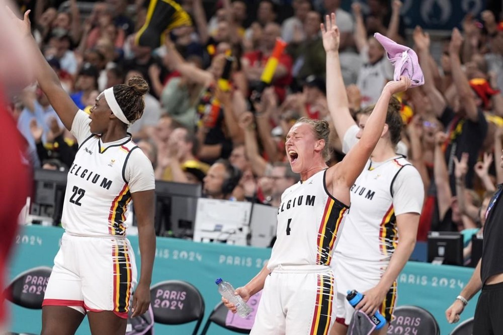 Belgium's Elisa Ramette, center, celebrates with teammates from the bench after they scored during a women's basketball game against the United States at the 2024 Summer Olympics, Thursday, Aug. 1, 2024, in Villeneuve-d'Ascq, France. (AP Photo/Michael Conroy)