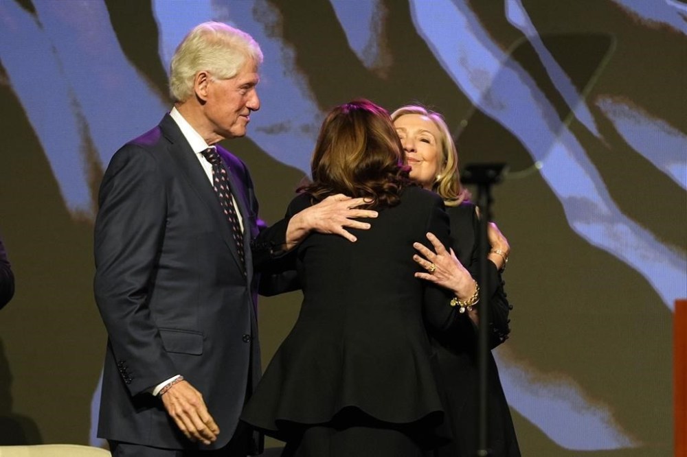 Former President Bill Clinton, left, looks on as former Secretary of State Hillary Clinton, right, hugs Vice President Kamala Harris at a eulogy for U.S. Rep. Sheila Jackson Lee, Thursday, Aug. 1, 2024, in Houston. (AP Photo/LM Otero)