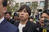 FILE - Ippei Mizuhara, center, the former interpreter for the Los Angeles Dodgers baseball player Shohei Ohtani, leaves federal court in Santa Ana, Calif., Tuesday, June 4, 2024, after pleading guilty to bank and tax fraud in a sports betting case. A Southern California bookmaker who took thousands of sports bets from Mizuhara has agreed to plead guilty to running an illegal gambling business, U.S. authorities announced Thursday, Aug. 1, 2024. (AP Photo/Damian Dovarganes,File)