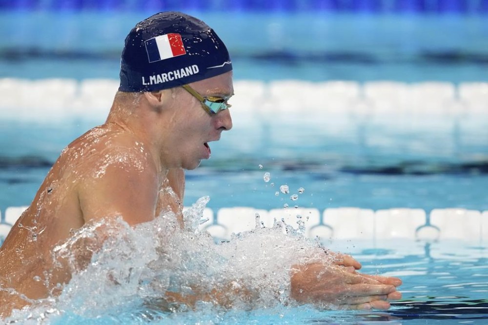 Leon Marchand, of France, competes in a men's 200-meter individual medley semifinal at the 2024 Summer Olympics in Nanterre, France, Thursday, Aug. 1, 2024. (AP Photo/Ashley Landis)