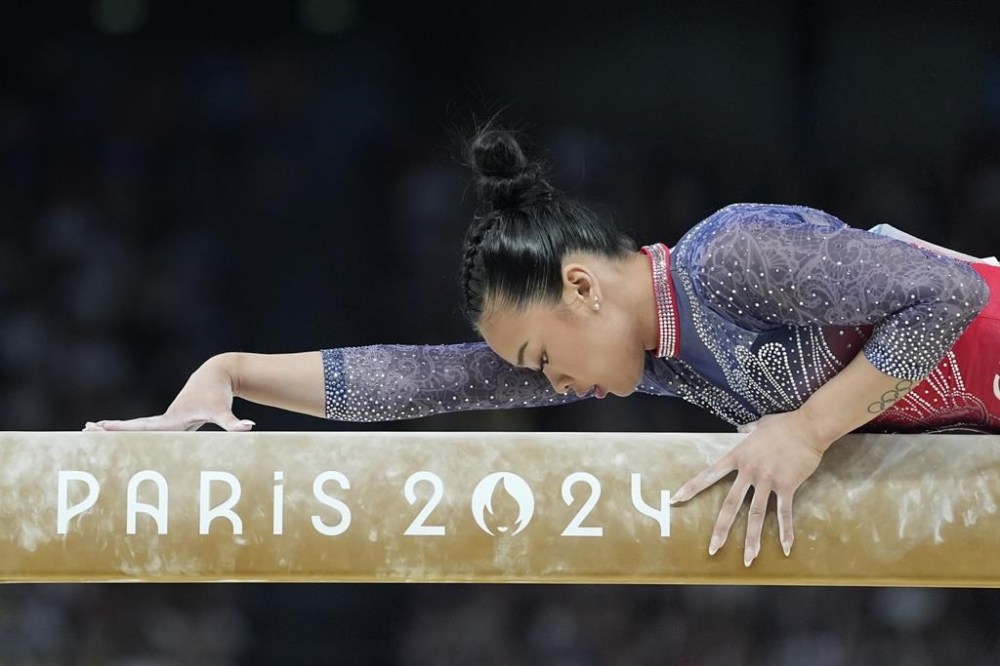 Suni Lee, of the United States, performs on the balance beam during the women's artistic gymnastics all-around finals in Bercy Arena at the 2024 Summer Olympics, Thursday, Aug. 1, 2024, in Paris, France. (AP Photo/Abbie Parr)