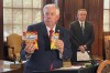 Missouri Gov. Mike Parson holds up an example of a legal package of Life Savers Gummies, left, and a slightly smaller package of hemp-derived gummies, right, at the Capitol in Jefferson City, Missouri. The hemp gummies will be banned under an executive order he issued prohibiting unregulated psychoactive cannabis products Thursday, Aug. 1, 2024. Mike Leara, right, supervisor of the state Division of Alcohol and Tobacco Control, will be responsible for making sure such products aren't sold at facilities with liquor licenses. (AP Photo/David A. Lieb)