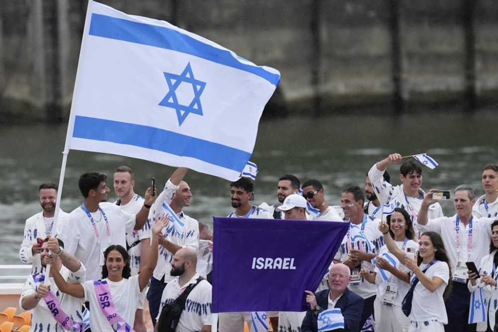 FILE — Israel's Andrea Murez and Peter Paltchik carry their country's flag in Paris, France, during the opening ceremony of the 2024 Summer Olympics, Friday, July 26, 2024. (AP Photo/Kirsty Wigglesworth, File)