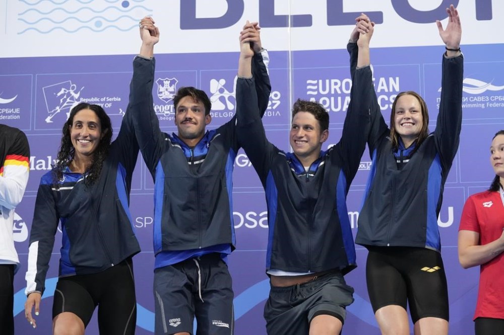 FILE — From left: winners Israel's Andrea Murez, Gal Cohen Groumi, Ron Polonsky and Anastasia Gorbenko celebrate during the medal ceremony for the mixed 4 x 100m medley relay at the European Aquatics Championships in Belgrade, Serbia, Tuesday, June 18, 2024. (AP Photo/Darko Bandic, File)