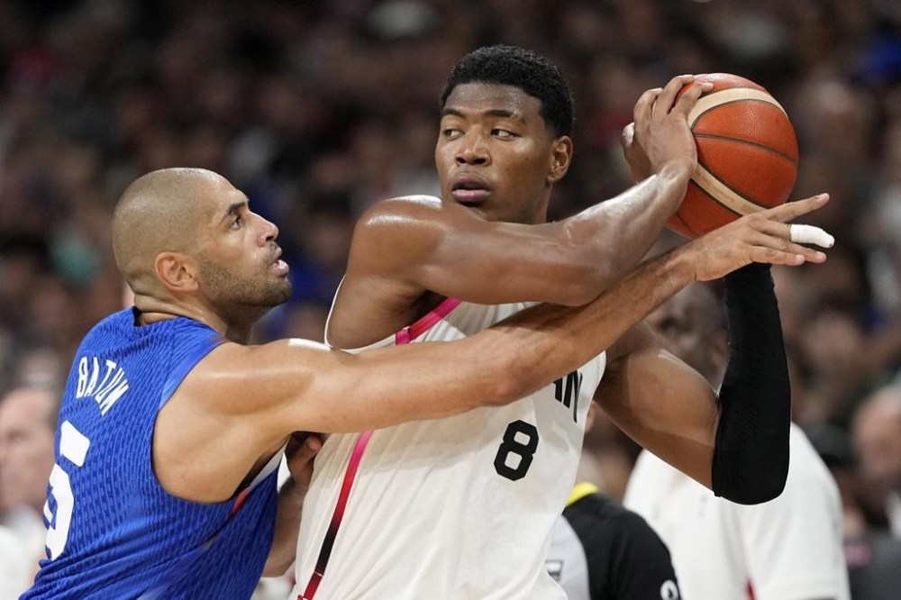 France's Nicolas Batum, left, reaches in on Japan's Rui Hachimura in a men's basketball game at the 2024 Summer Olympics, Tuesday, July 30, 2024, in Villeneuve-d'Ascq, France. (AP Photo/Michael Conroy)