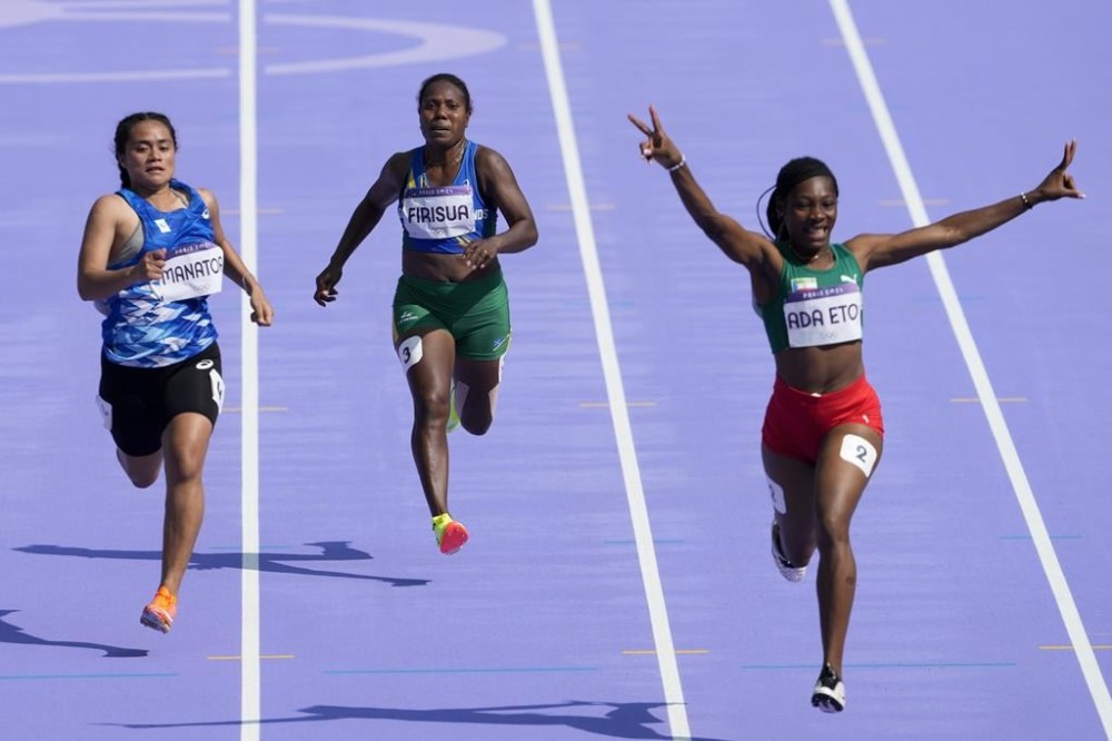 Sharon Firisua, middle, of Solomon Islands, competes in the women's 100-meter run at the 2024 Summer Olympics, Friday, Aug. 2, 2024, in Saint-Denis, France. (AP Photo/Martin Meissner)