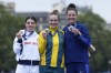 Grace Brown, of Australia, centre, shows the gold medal of the women's cycling time trial event, flanked by silver medallist Anna Henderson, of Britain, left, and bronze medallist Chloe Dygert, of United States, at the 2024 Summer Olympics, Saturday, July 27, 2024, in Paris, France. (AP Photo/Ricardo Mazalan)