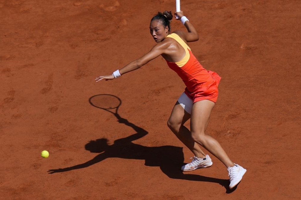 Zheng Qinwen of China plays against Iga Swiatek of Poland during their women's semifinals match, at the 2024 Summer Olympics, Thursday, Aug.1, 2024, at the Roland Garros stadium in Paris, France.